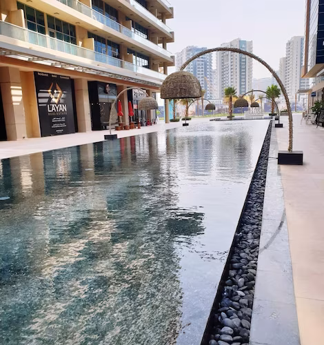 street-light-by-pond-amidst-buildings-city_1048944-4290938
